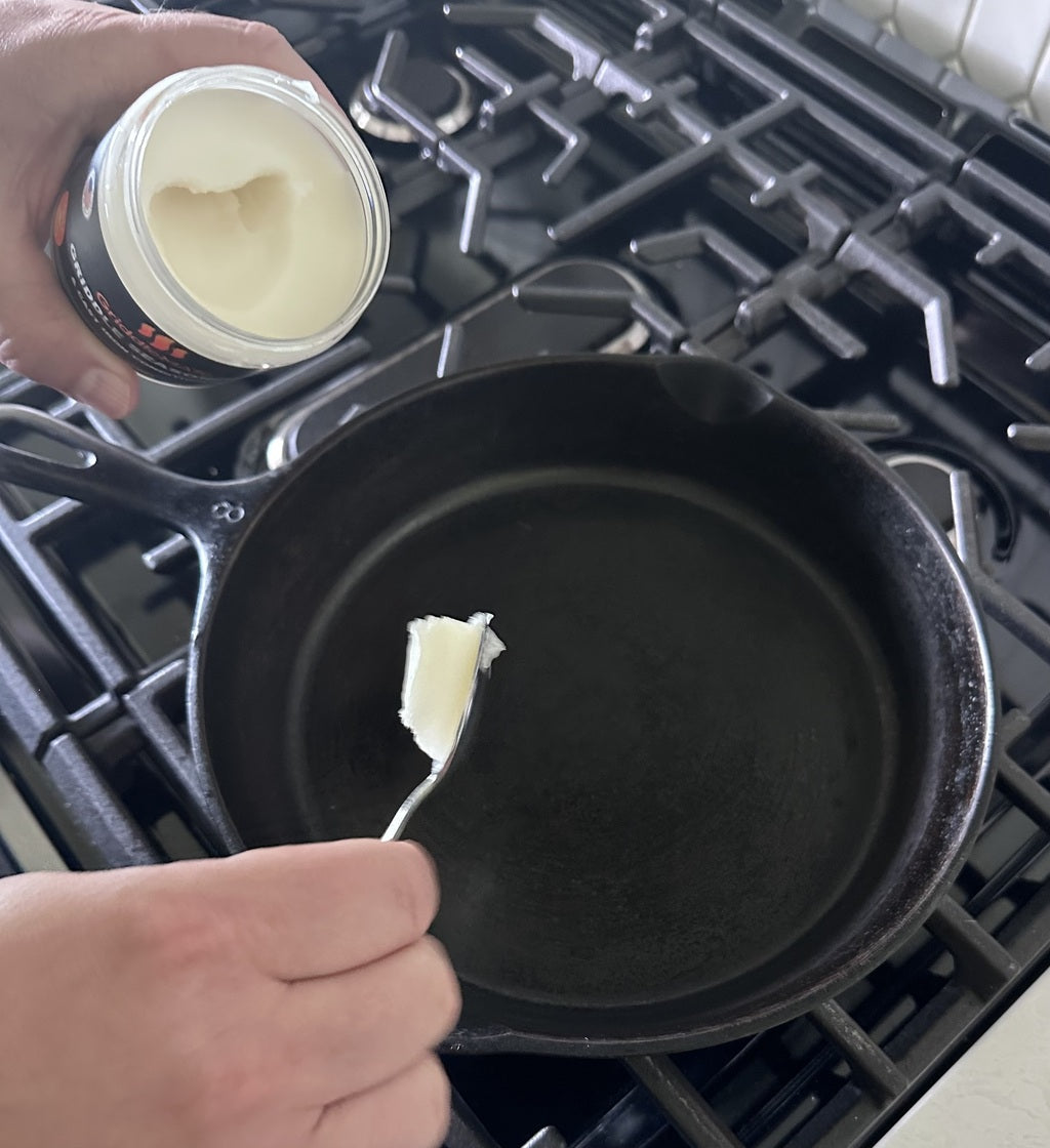 GriddleMATe seasoning being applied to a hot cast iron pan – ideal for cast iron and flat top seasoning and conditioning